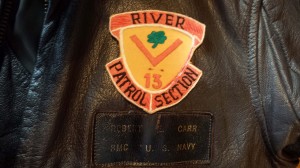 A patch from Chief Carr’s Vietnam unit, and his older navy jacket reading “Robert E. Carr, BMC, U.S. Navy”